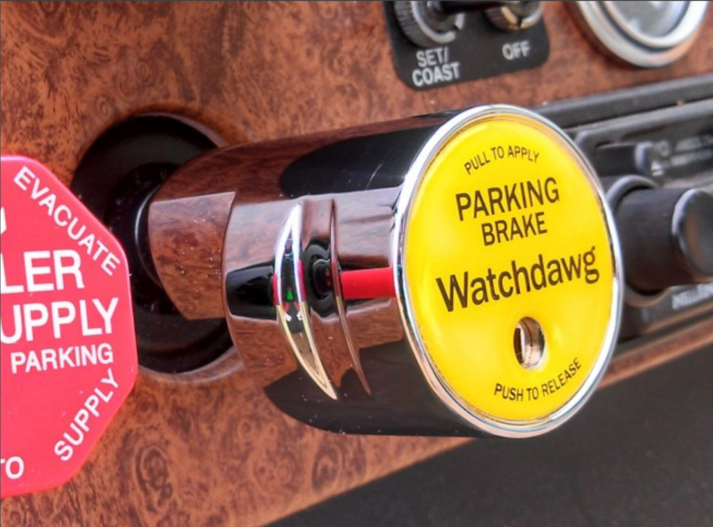 A Neffco security products Watchdawg truck theft prevention device installed on a truck dashboard.